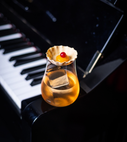 A refreshing drink perched on a piano, creating a harmonious blend of music and taste. Cheers to the perfect melody of flavors!